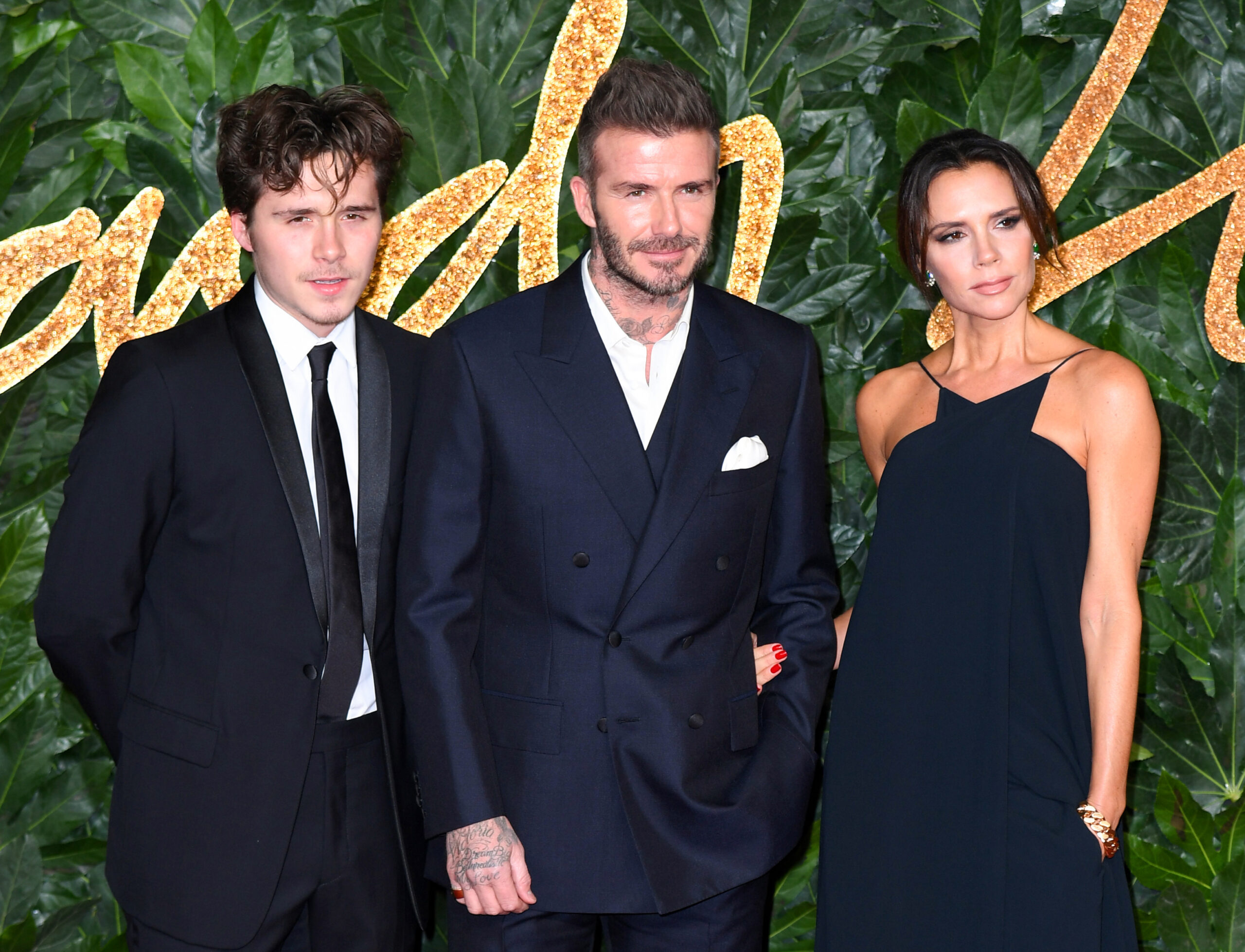 David, Brooklyn and Victoria at an event 