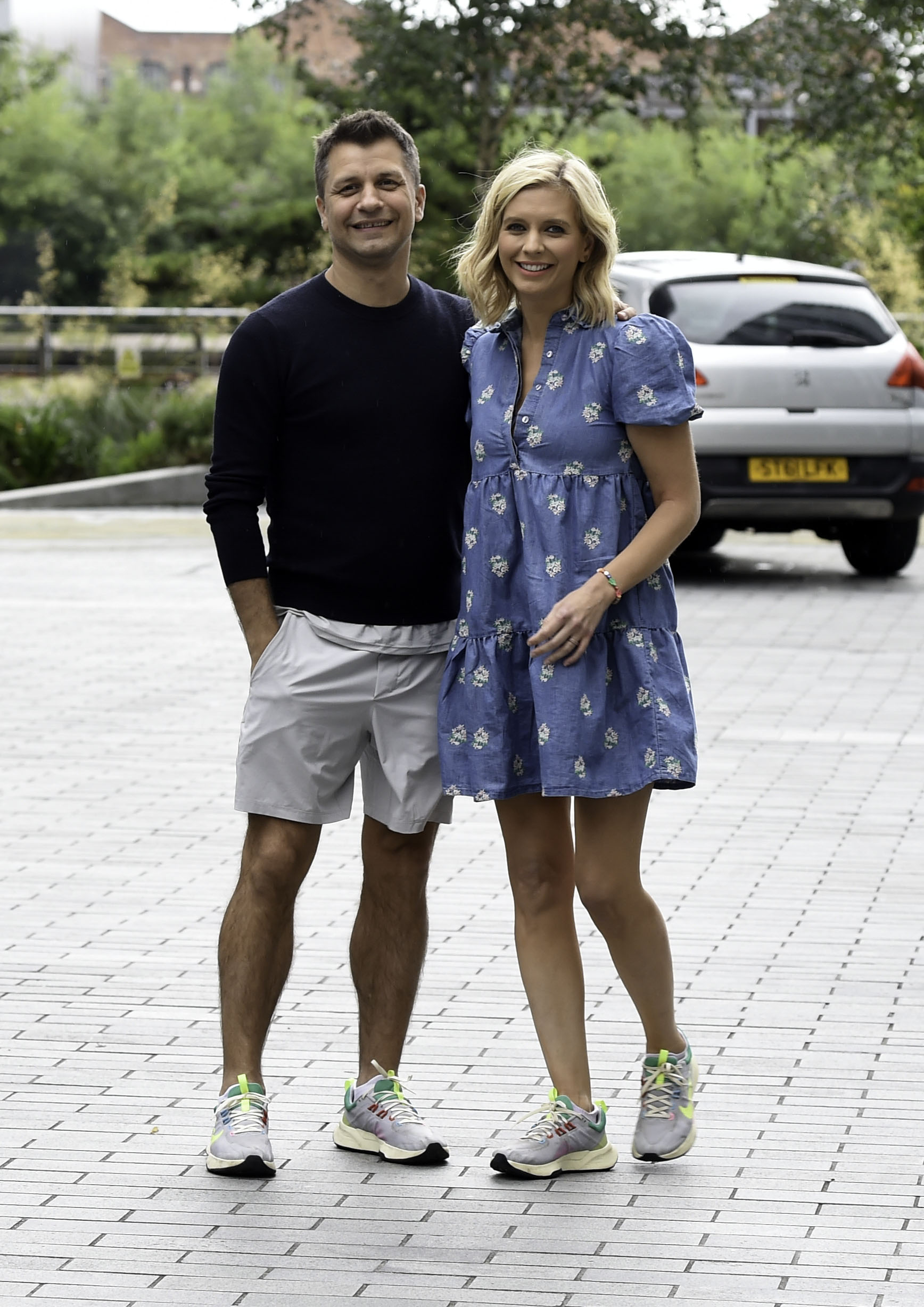 Pasha and Rachel smiling outside at an event 
