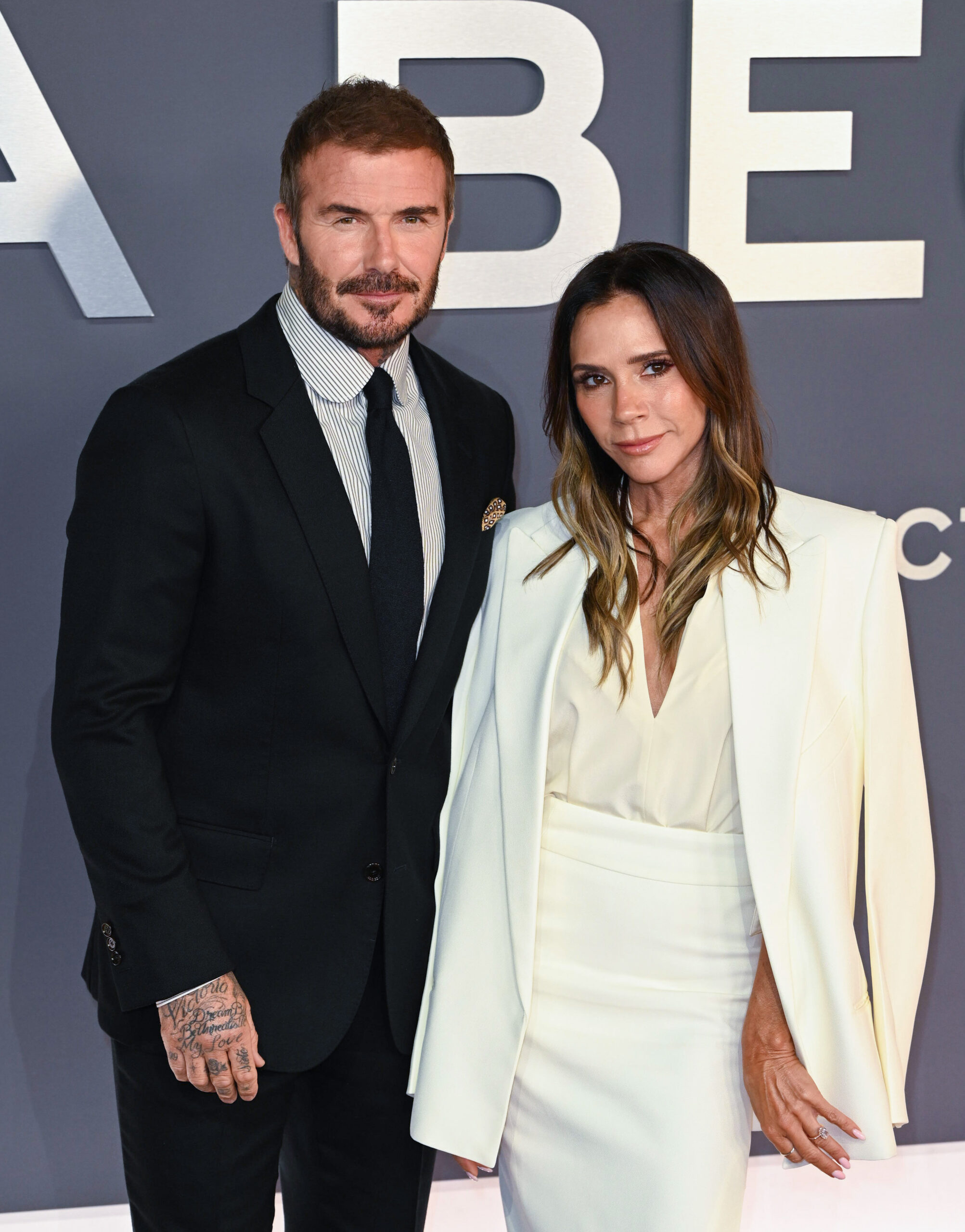 David and Victoria Beckham smiling at event