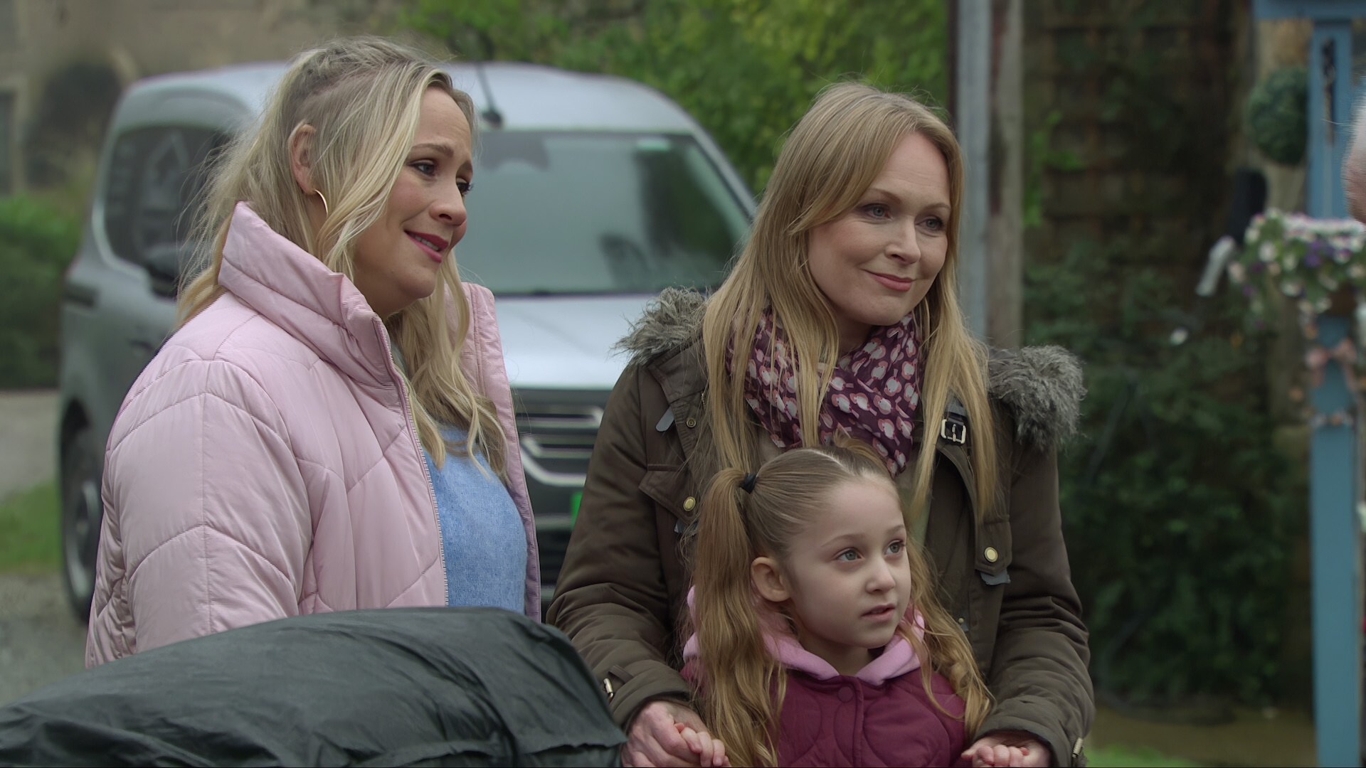 Tracy, Vanessa and Frankie smile sadly