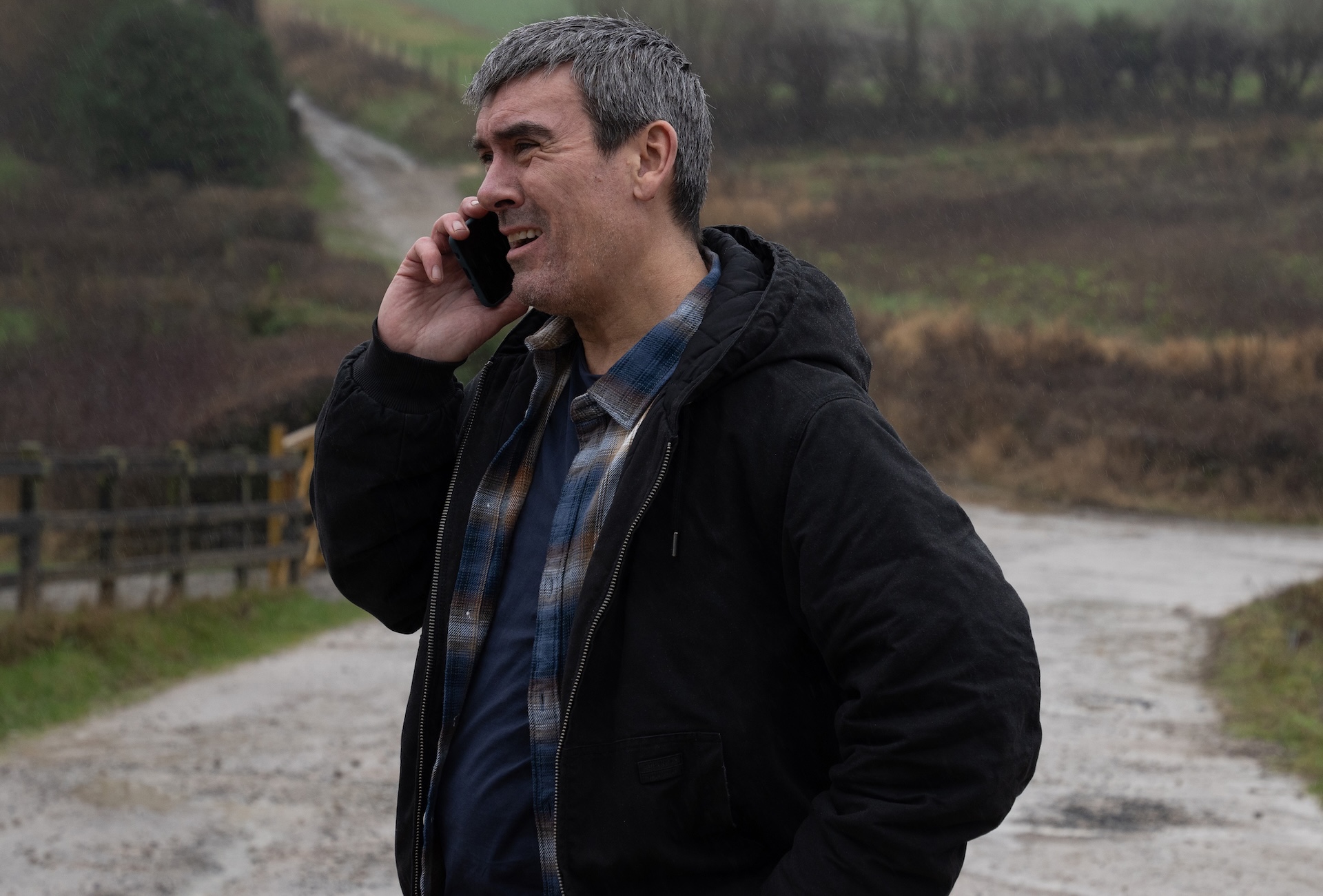 Cain Dingle on the phone on a country road