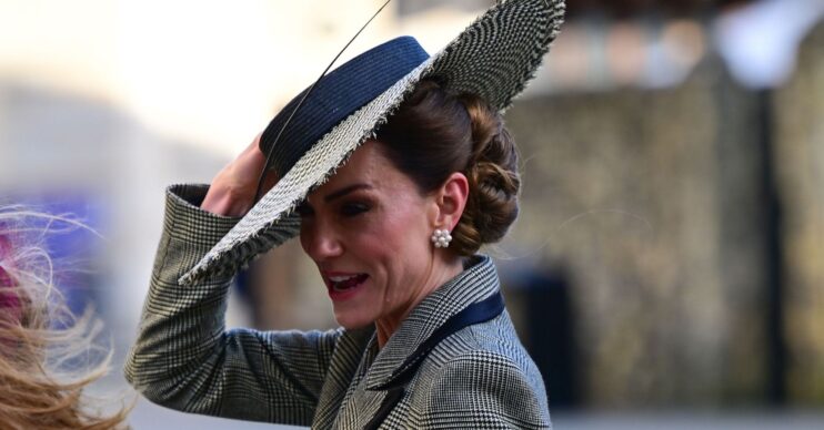 Kate Middleton holding onto her hat