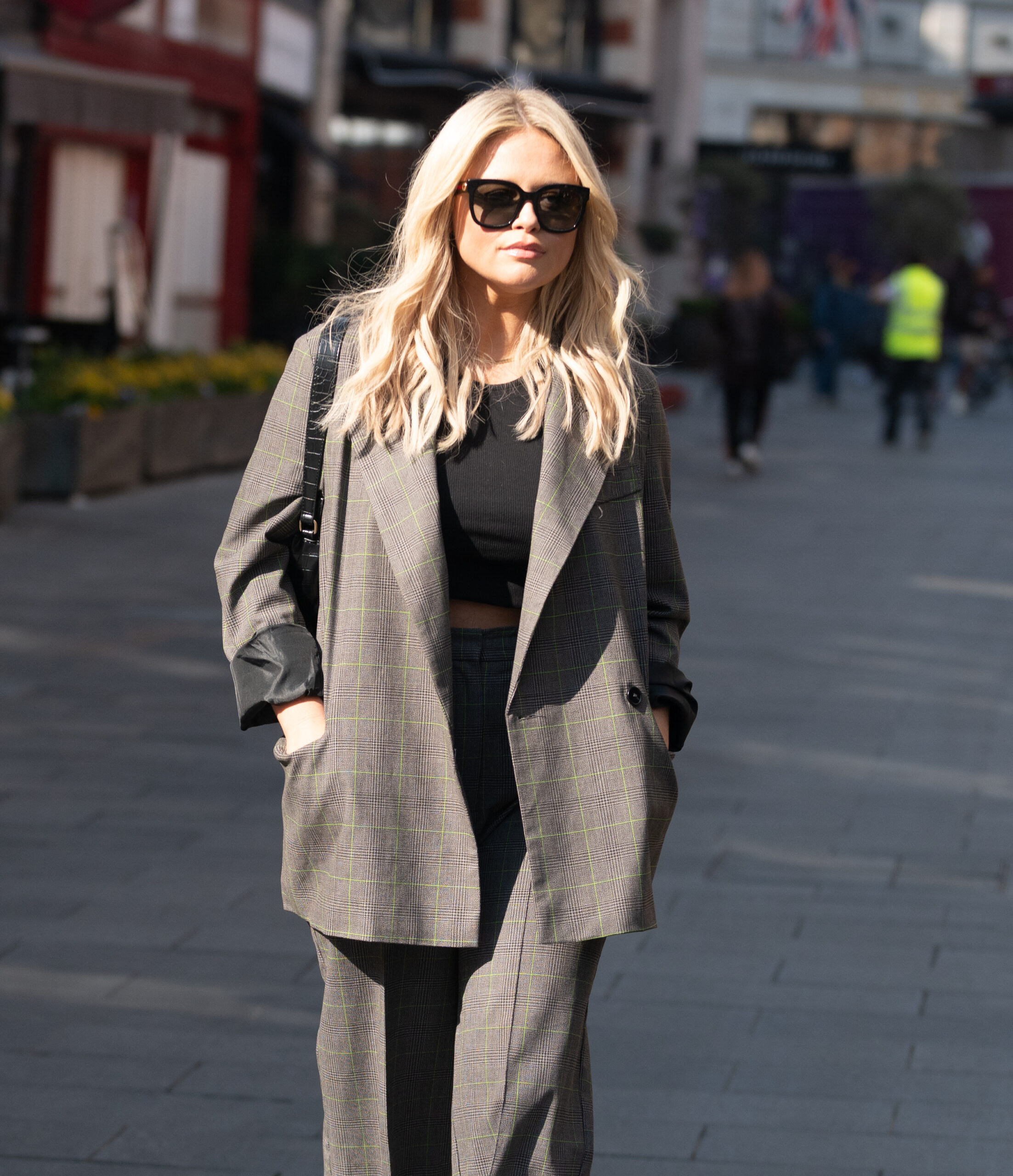 Emily Atack walking wearing sunglasses 