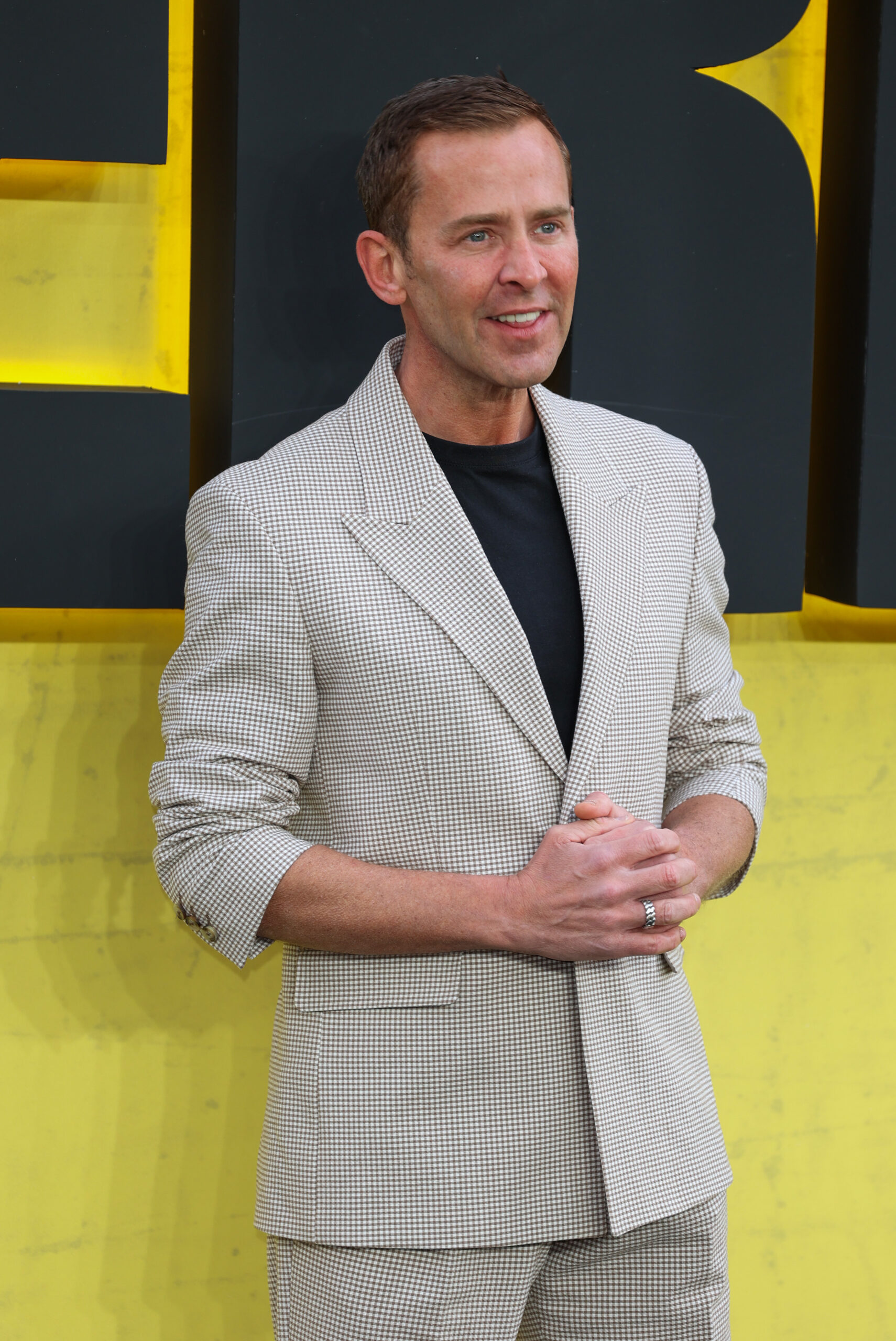 Scott Mills posing on the red carpet at a premiere
