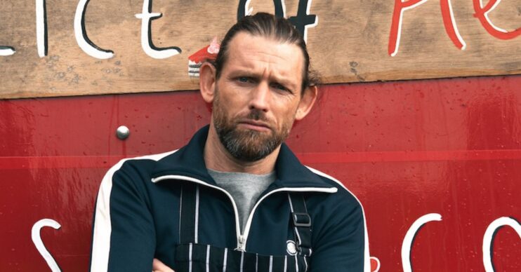 Kev posing at his new business venture in Emmerdale