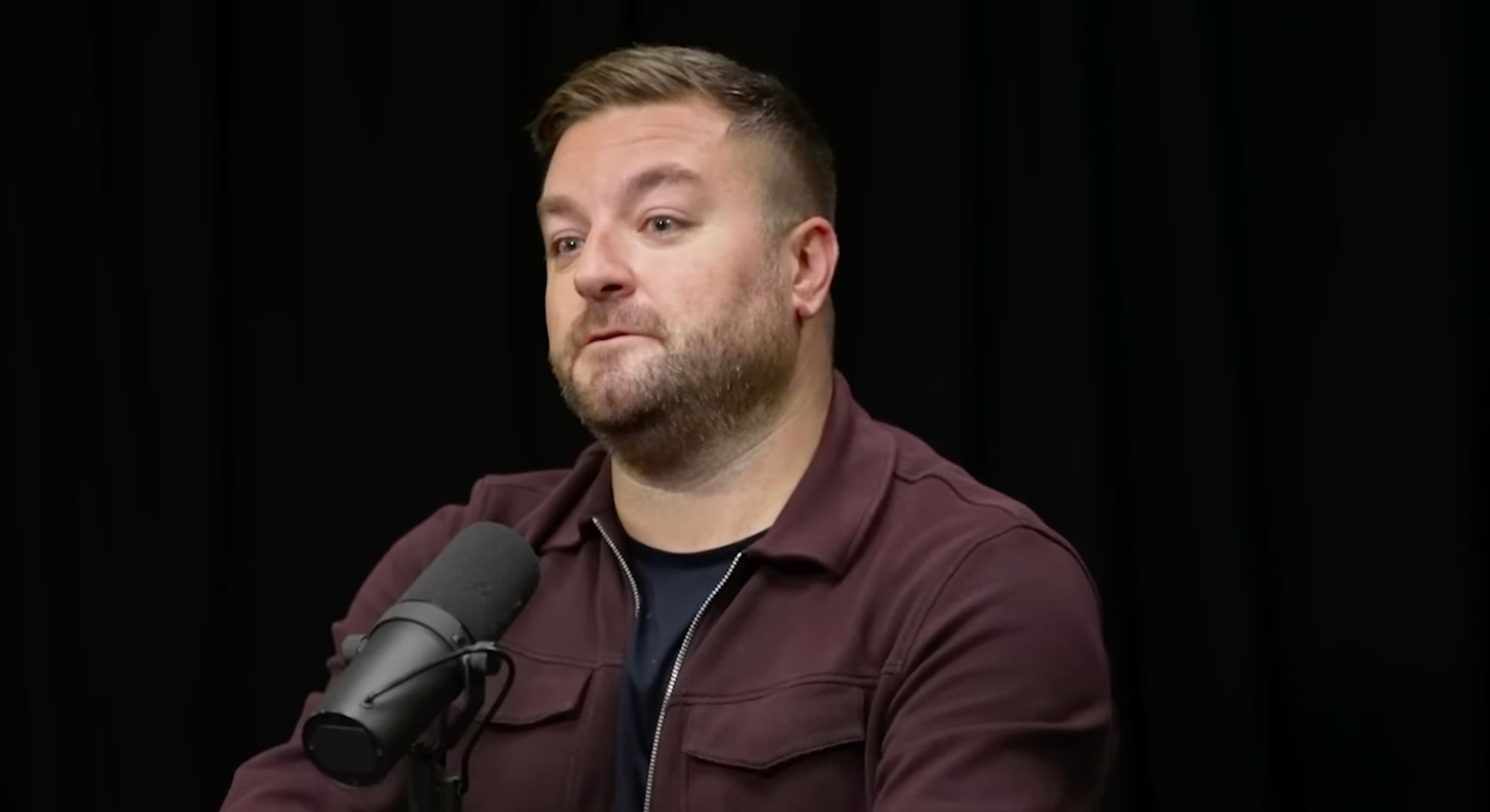 Alex Brooker on a podcast 