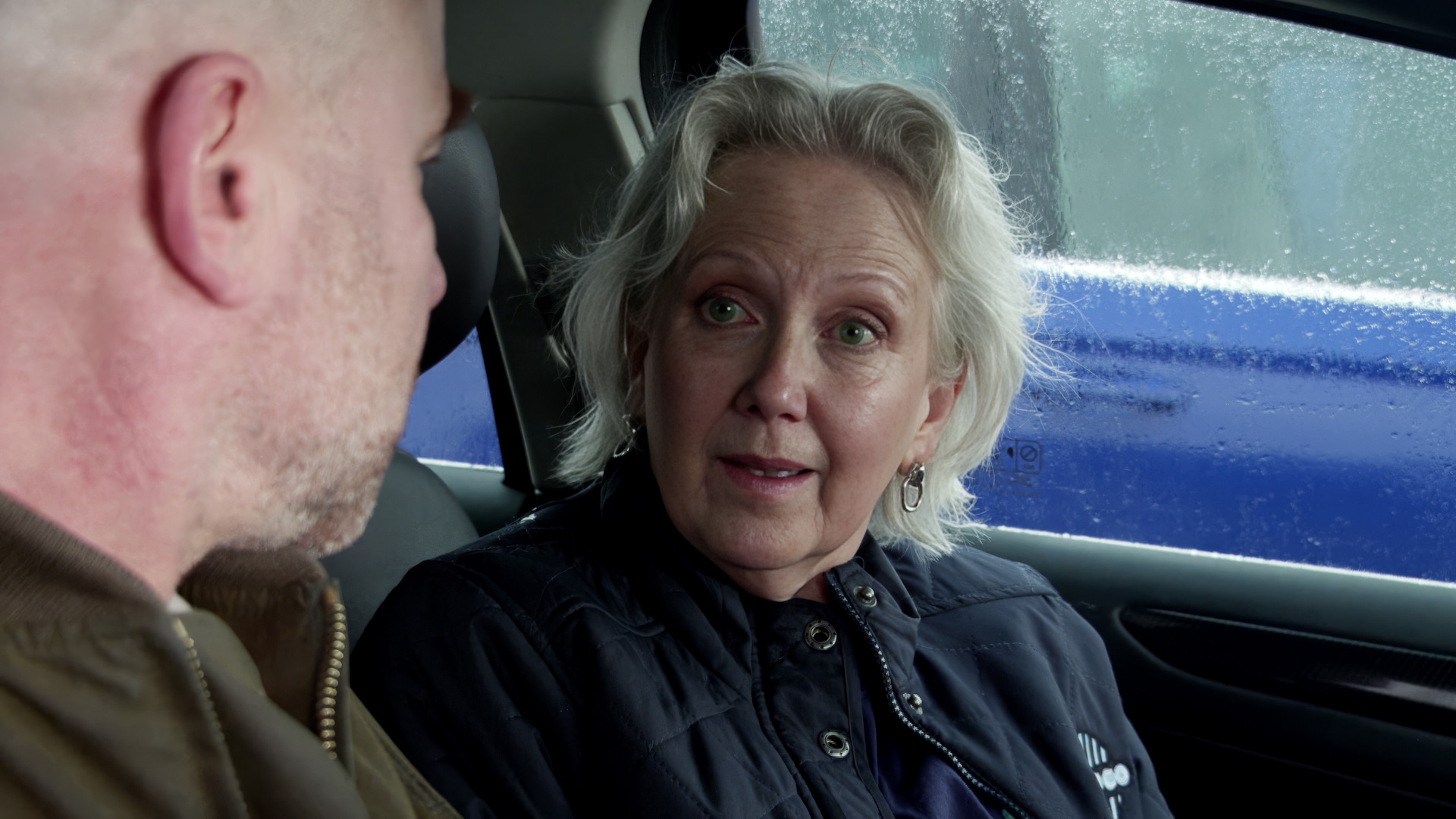 Tricia serious in cab in Coronation Street