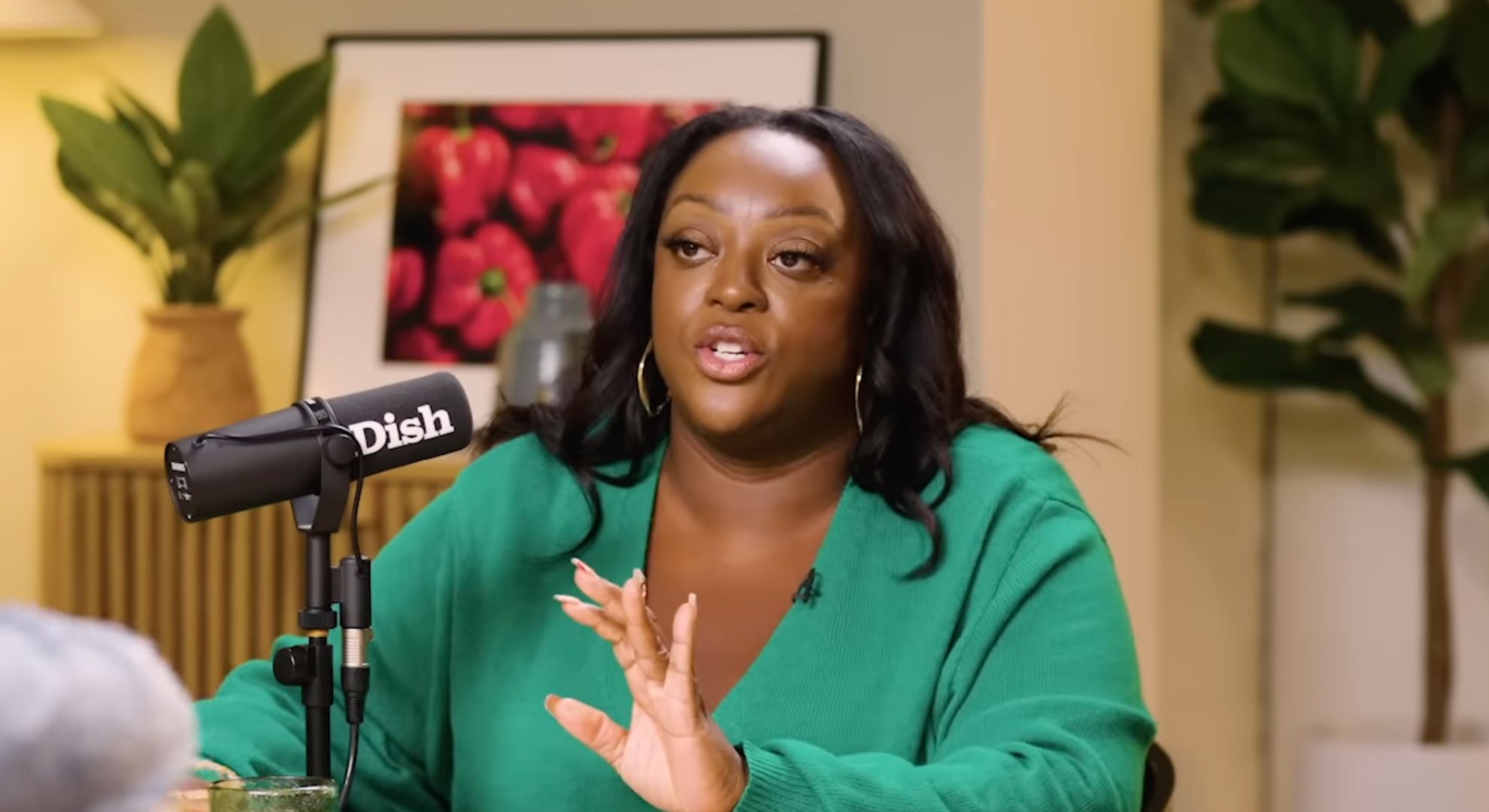 Judi Love on a podcast