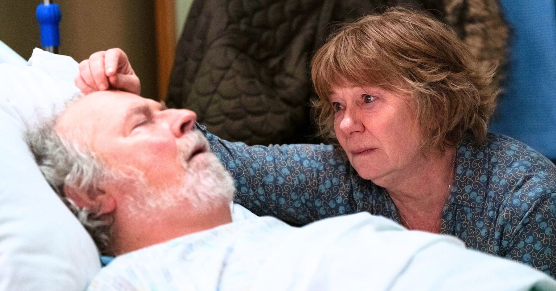 Nigel lying in bed which Julie by his side