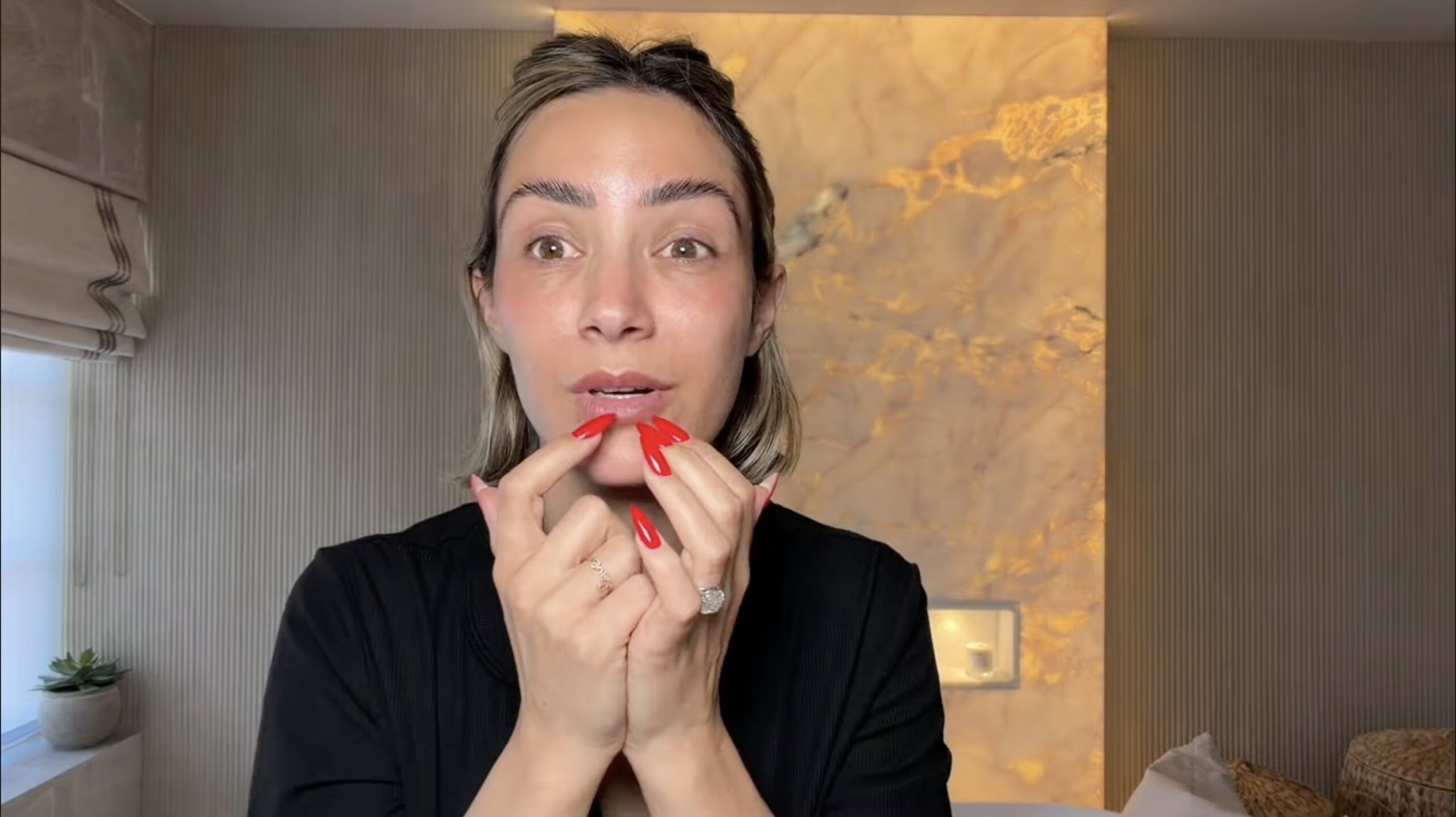 Frankie Bridge pointing to her lips