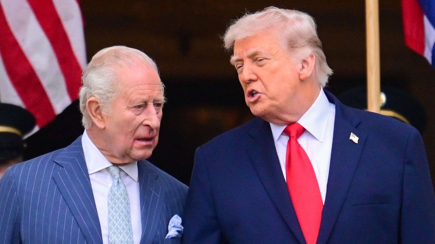 King Charles and Donald Trump conversing with serious expressions