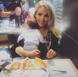 Woman with baby and glass of wine 