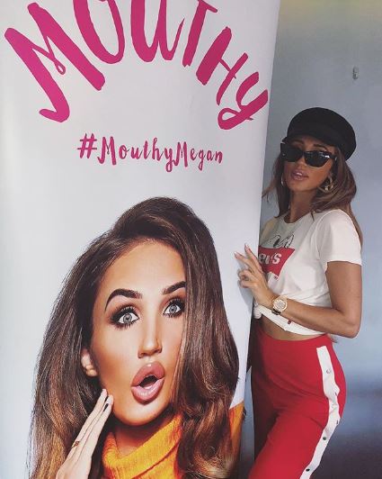 Megan McKenna with the cover of her book