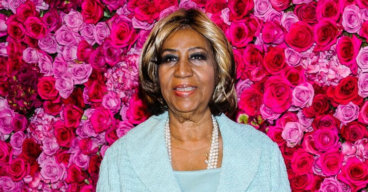 Aretha Franklin against a flower board backdrop