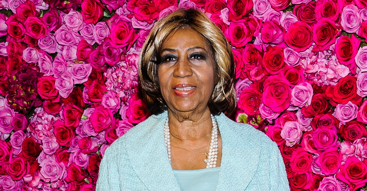 Aretha Franklin against a flower board backdrop