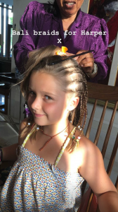 Harper Beckham having her hair done on holiday