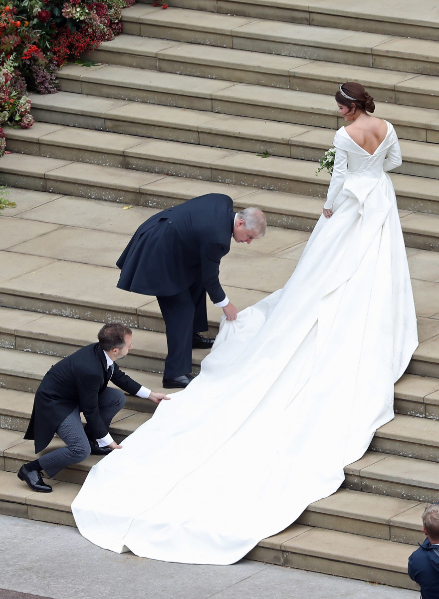 Princess Eugenie of York receives help with her train from her father Prince Andrew, Duke of York as she arrives to her wedding to Mr. Jack Brooksbank at St. George's Chapel on October 12, 2018 in Windsor, England. (Photo by Andrew Matthews - WPA Pool/Getty Images)