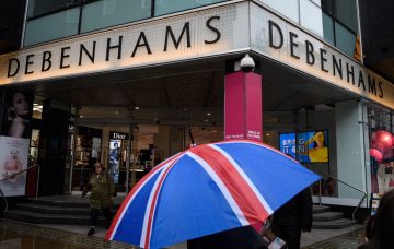 Shoppers pass a branch of the Debenhams chain of department stores on Oxford Street