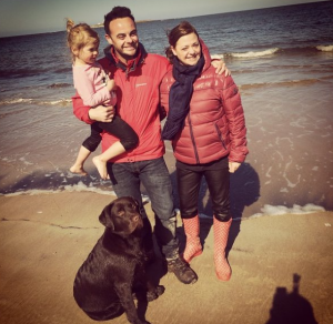 Ant and Lisa with their dog on holiday 