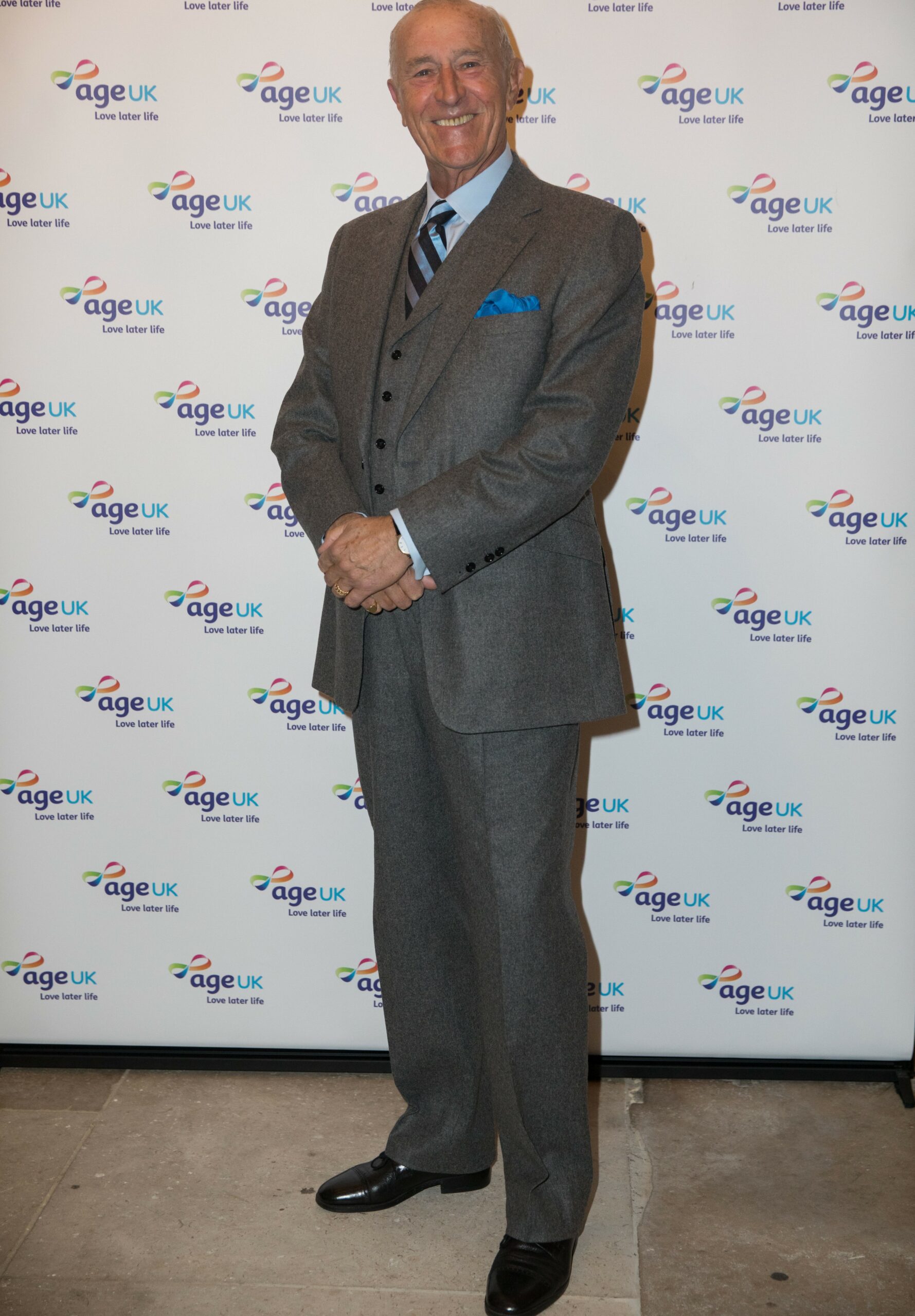 Len Goodman smiling in suit at event