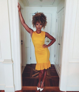 Fleur East poses yellow dress