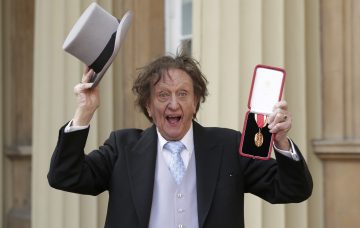 Entertainer Ken Dodd poses for photographers after being made a Knight Bachelor of the British Empire by Britain's Prince William at an investiture at Buckingham Palace in central London