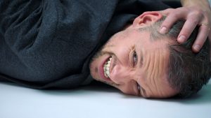 What has Evan done to deserve being pinned to a table by Dom? (Credit: BBC)