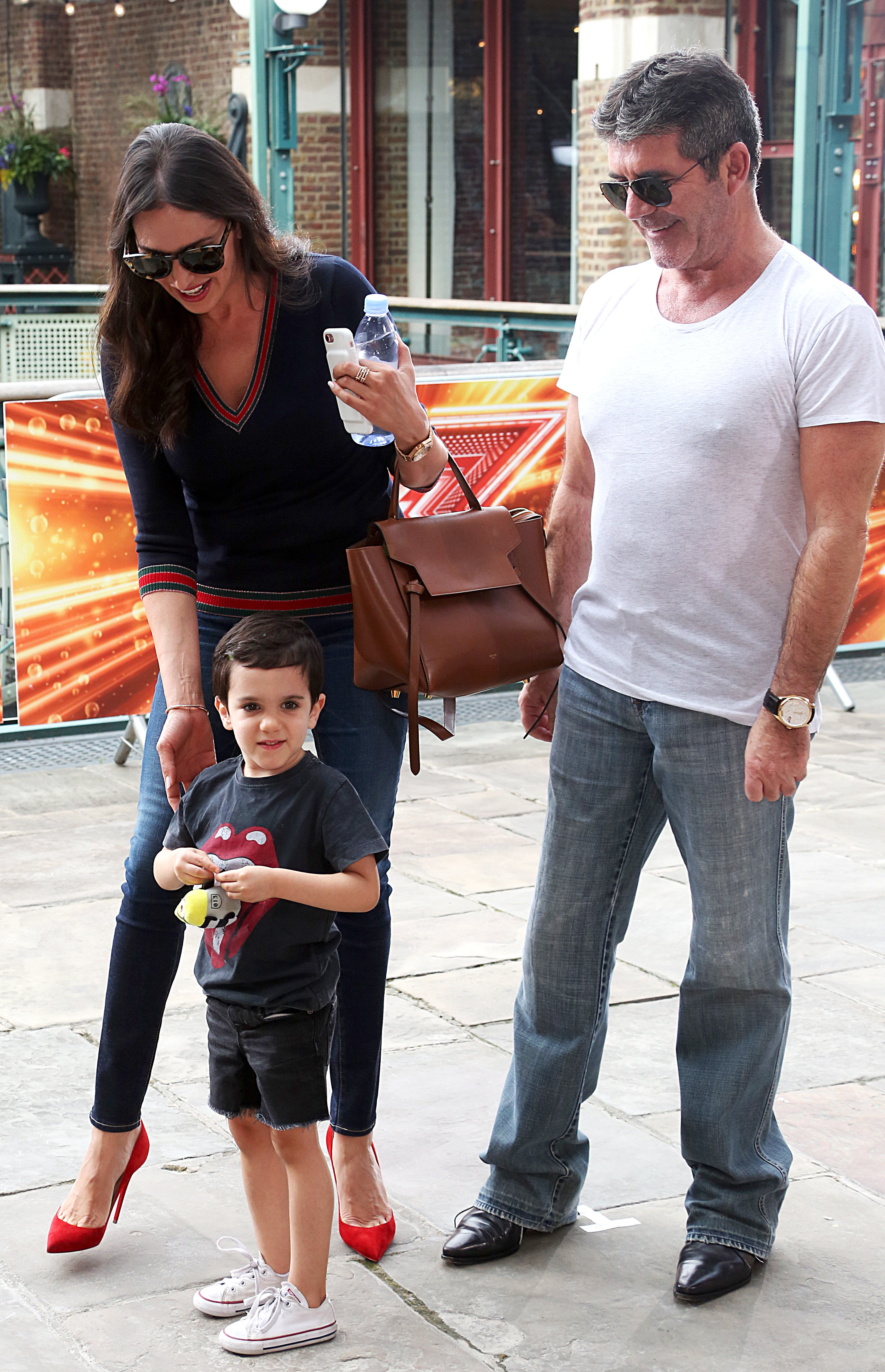 Simon Cowell smiling with son Eric and his mum Lauren