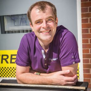 Steve McDonald smiles on Coronation Street
