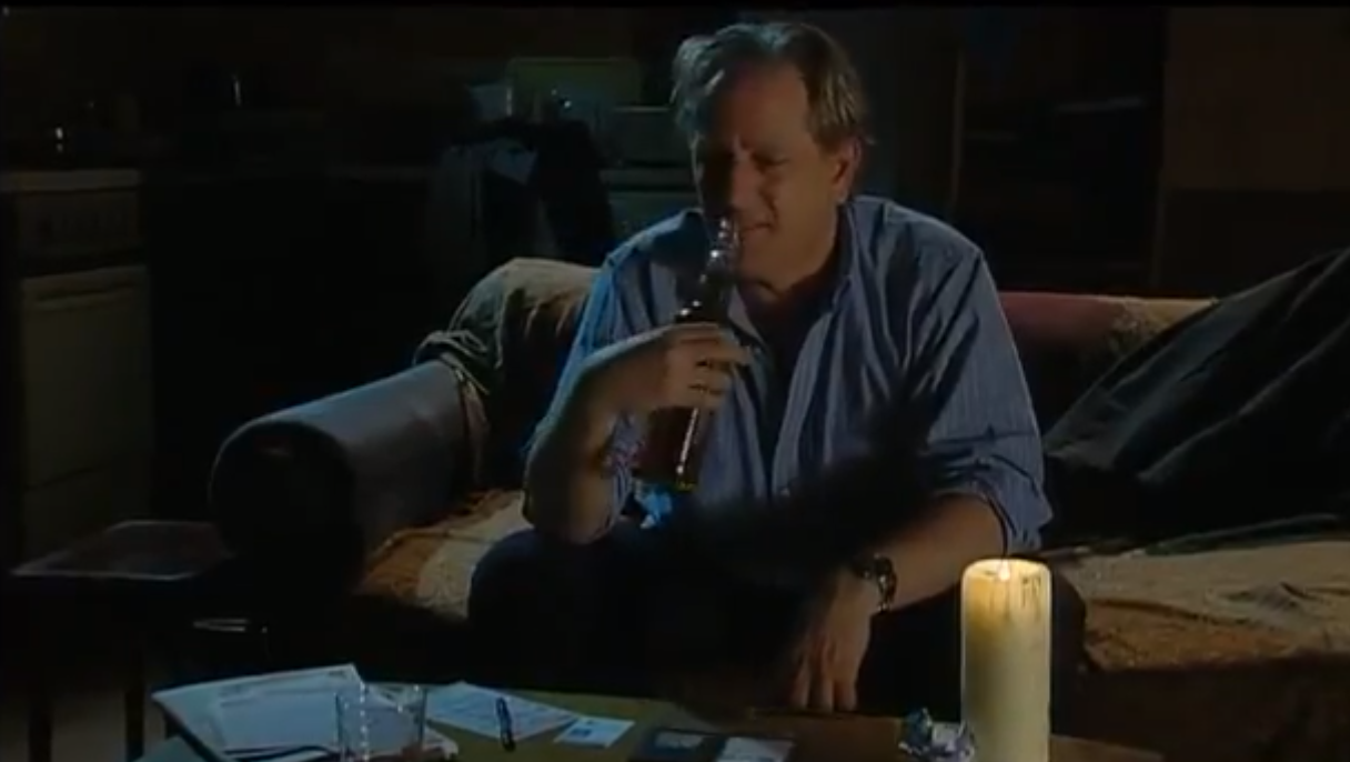 Jim Carver from The Bill drinking on his sofa