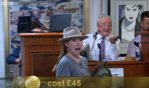 Rosie held up the stain glass panel at the auction