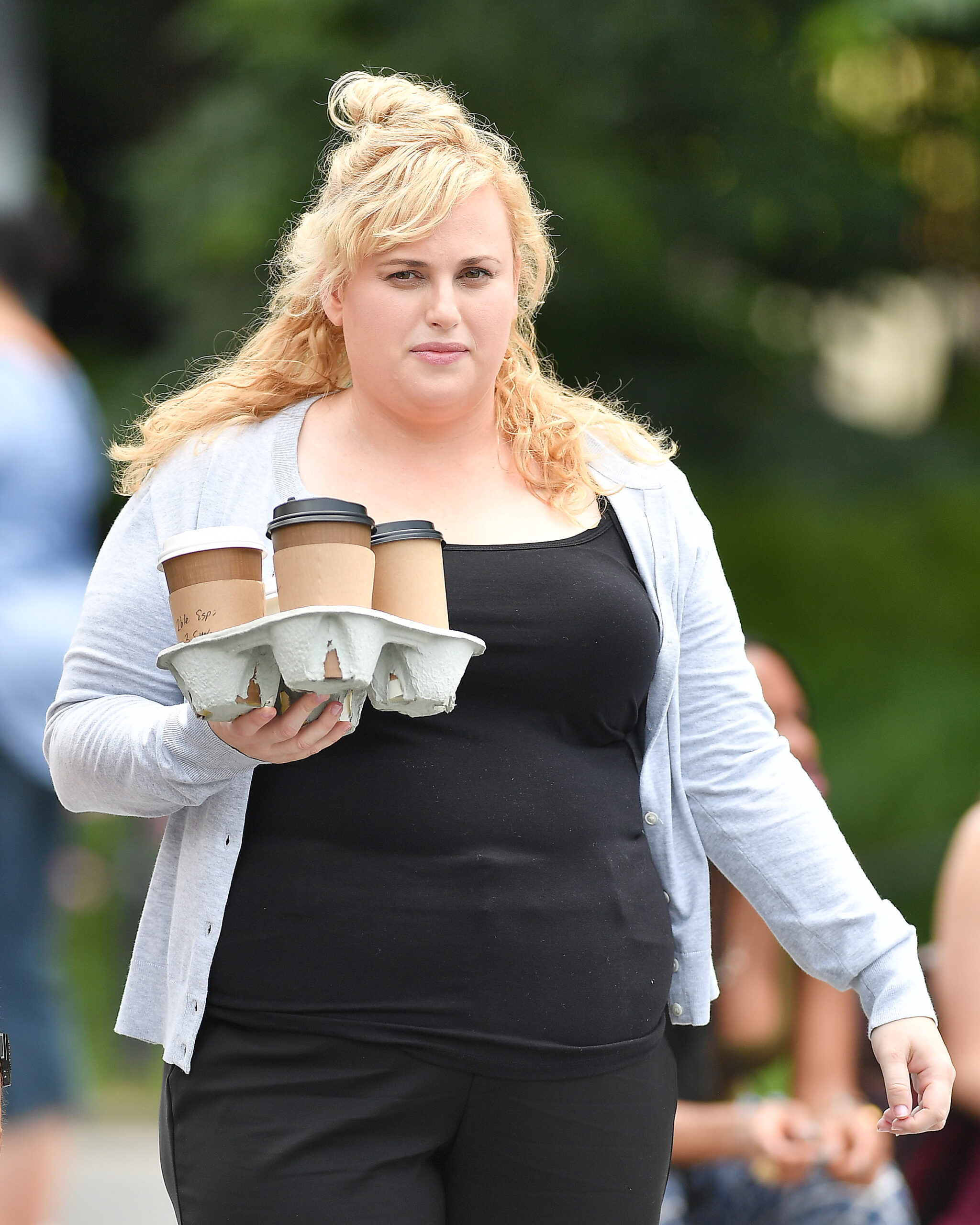 Rebel Wilson carrying coffees