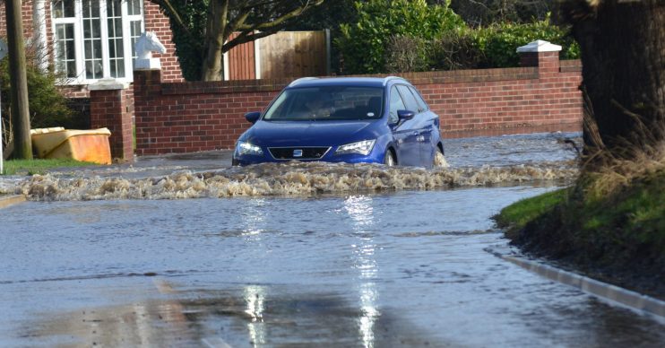 Car driving through flood water