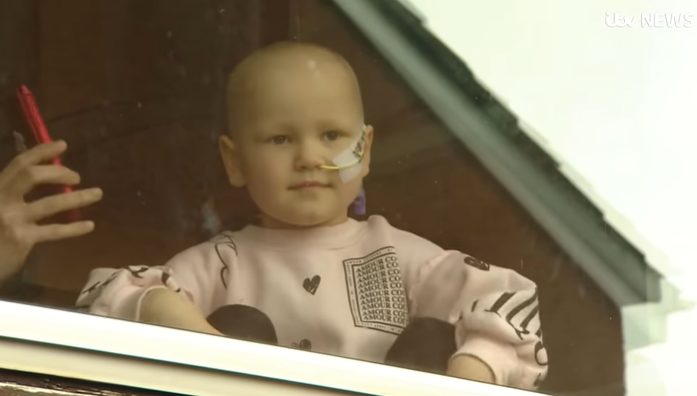 Mila is battling cancer and can only speak to her dad through a window (Credit: ITV News/YouTube)