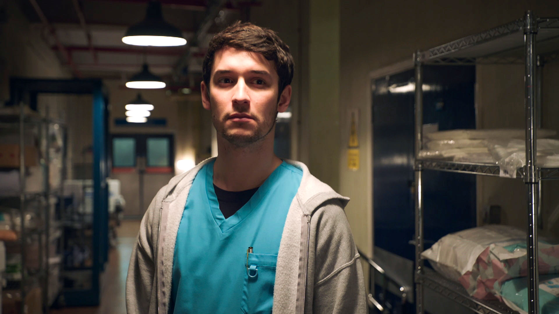 Holby City Cameron Dunn looks sinister in the corridor of the hospital