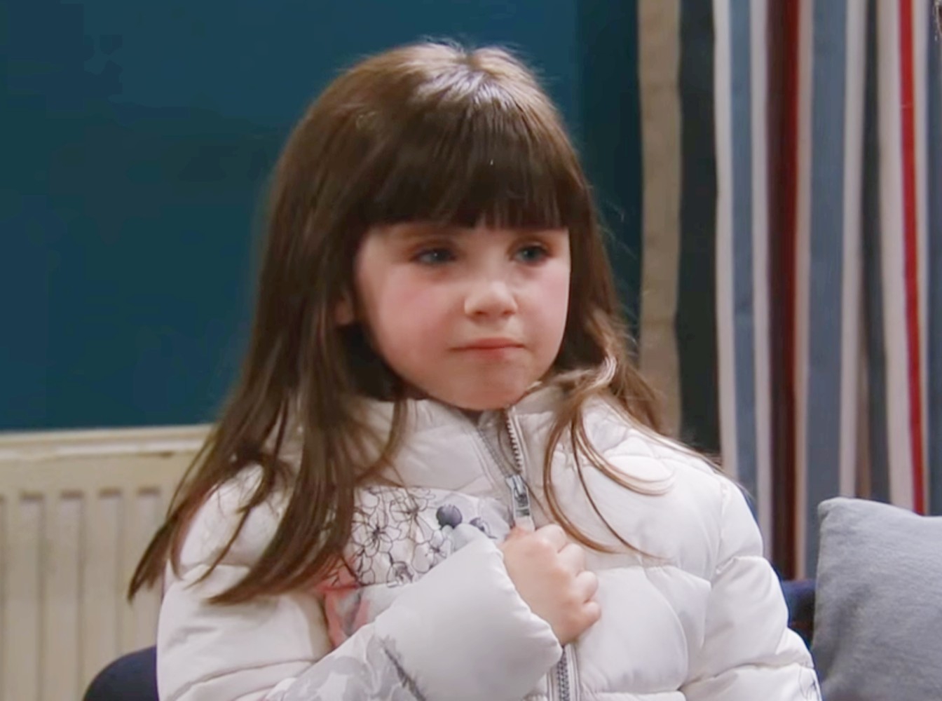April Windsor looks sad as she unzips her coat