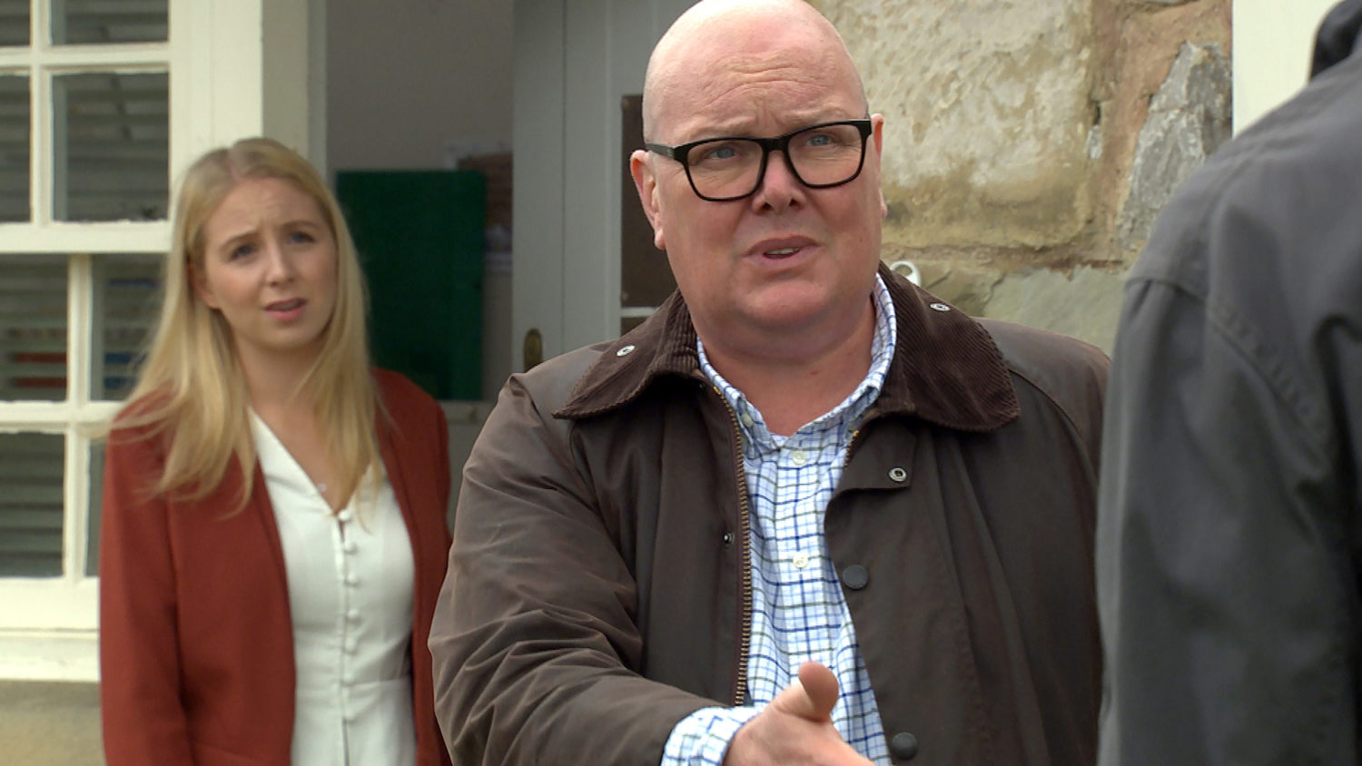 Belle Dingle watches as Paddy looks angry yet worried in Emmerdale (Credit: ITV)