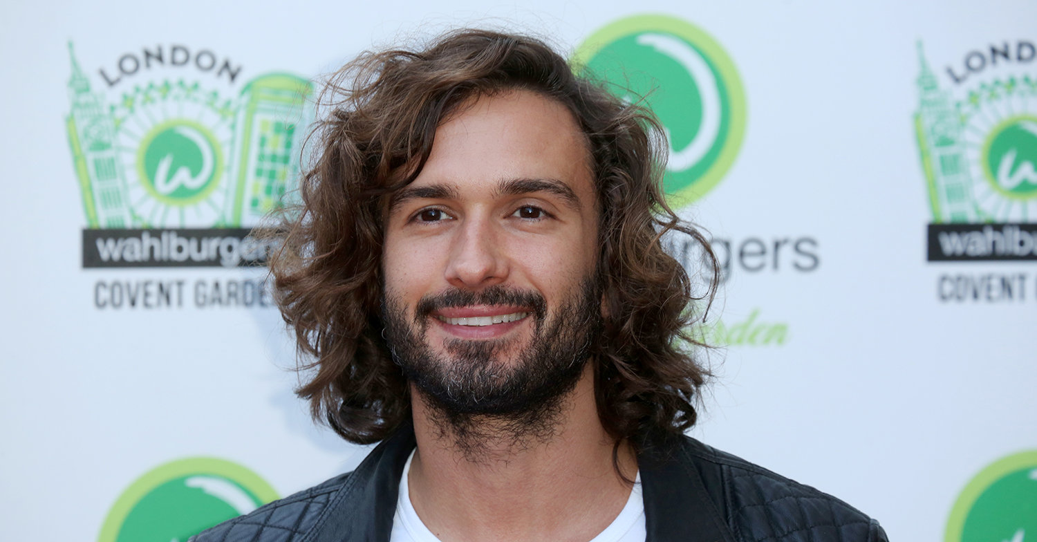 Joe Wicks smiles on a red carpet
