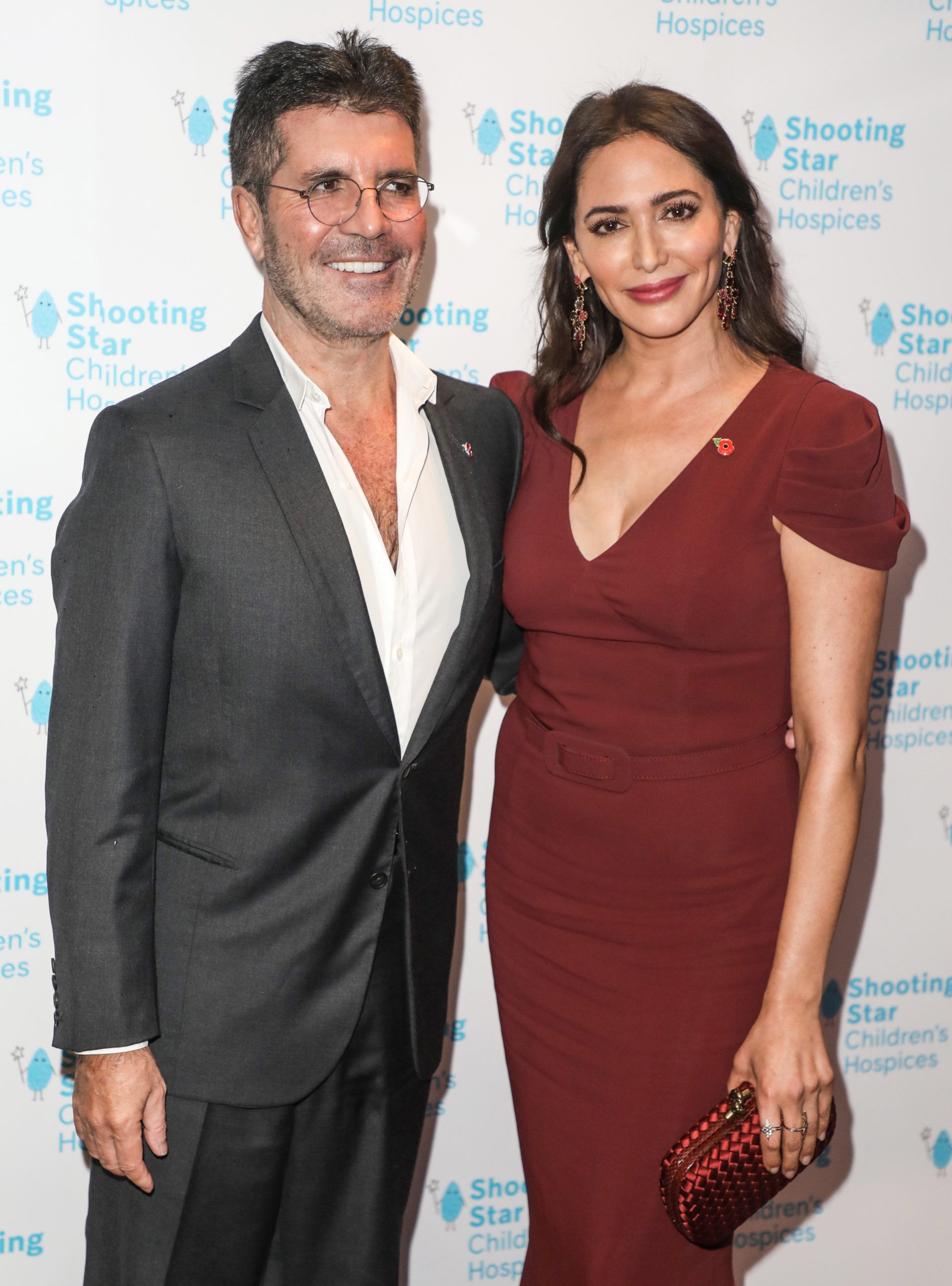 Simon Cowell, who injured his back, and his wife Lauren