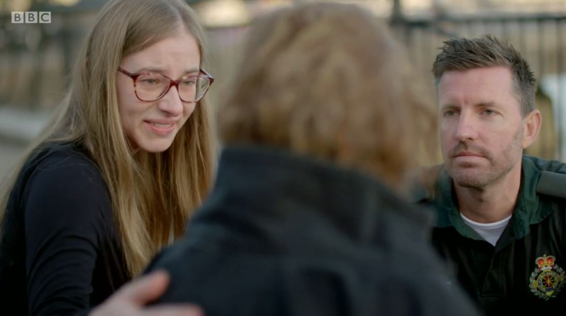 A bystander comforting a patient on BBC Ambulance
