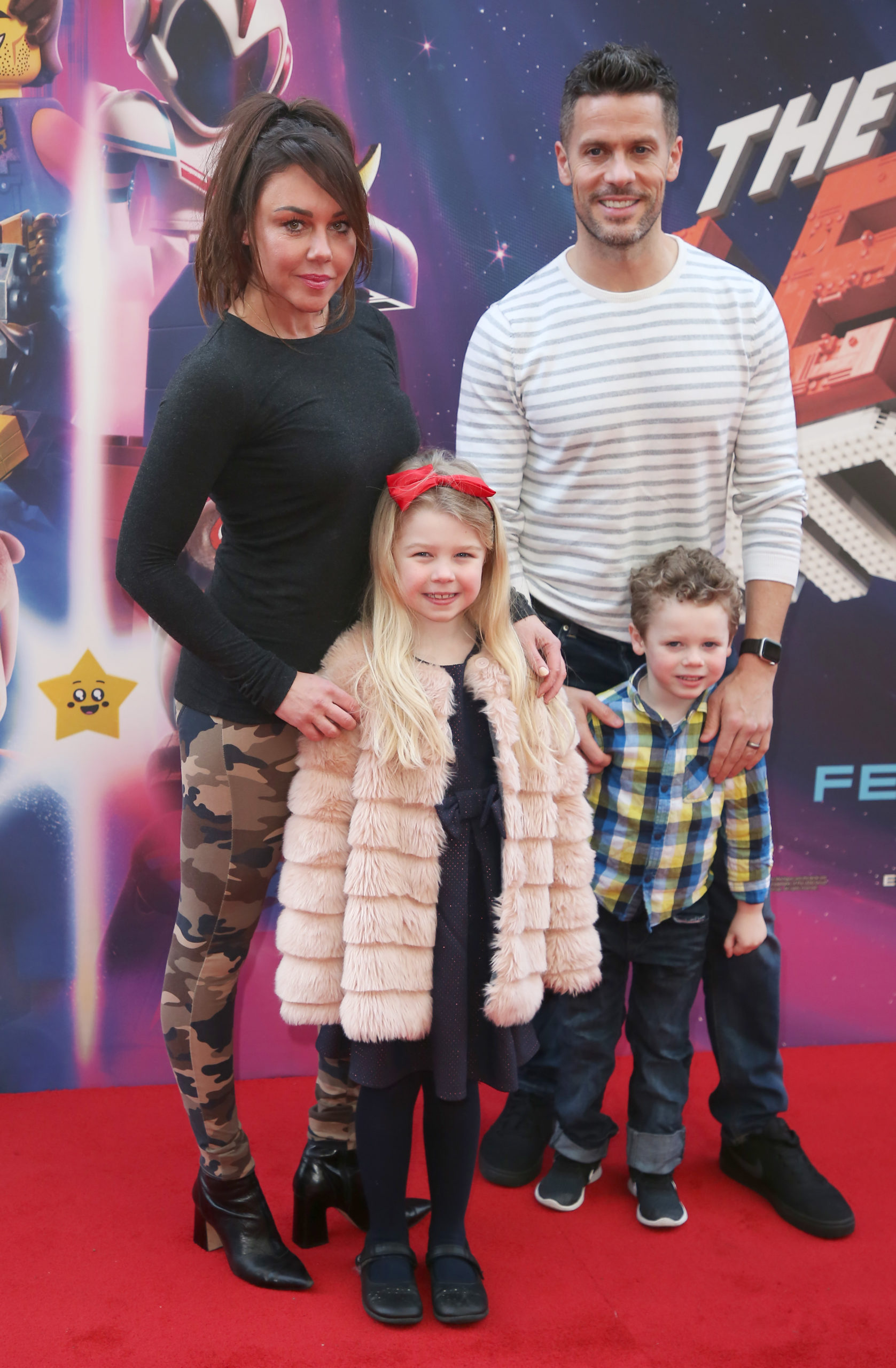 Michelle Heaton with her kids and husband posing at a premiere