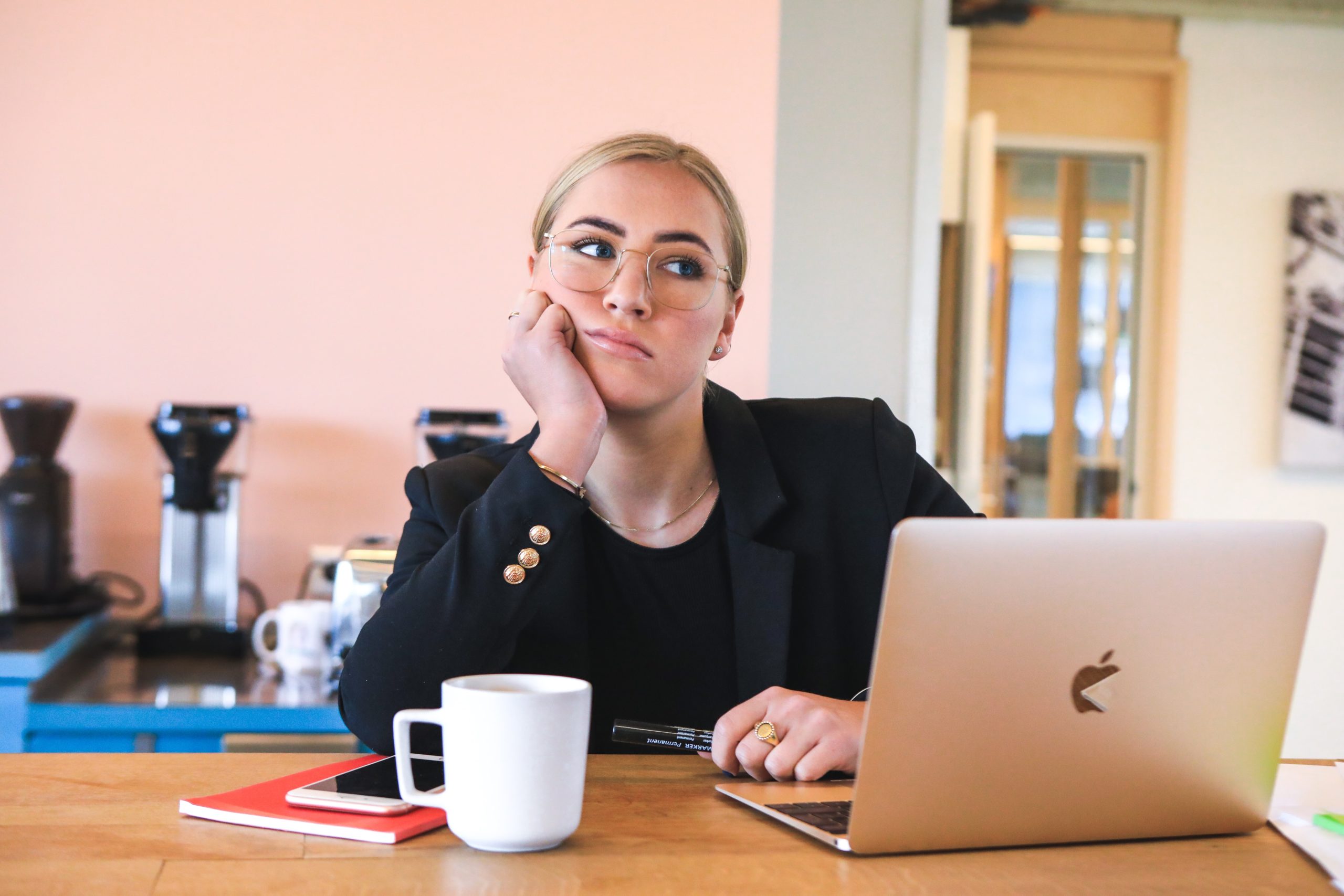 woman sitting at her laptop looking unhappy