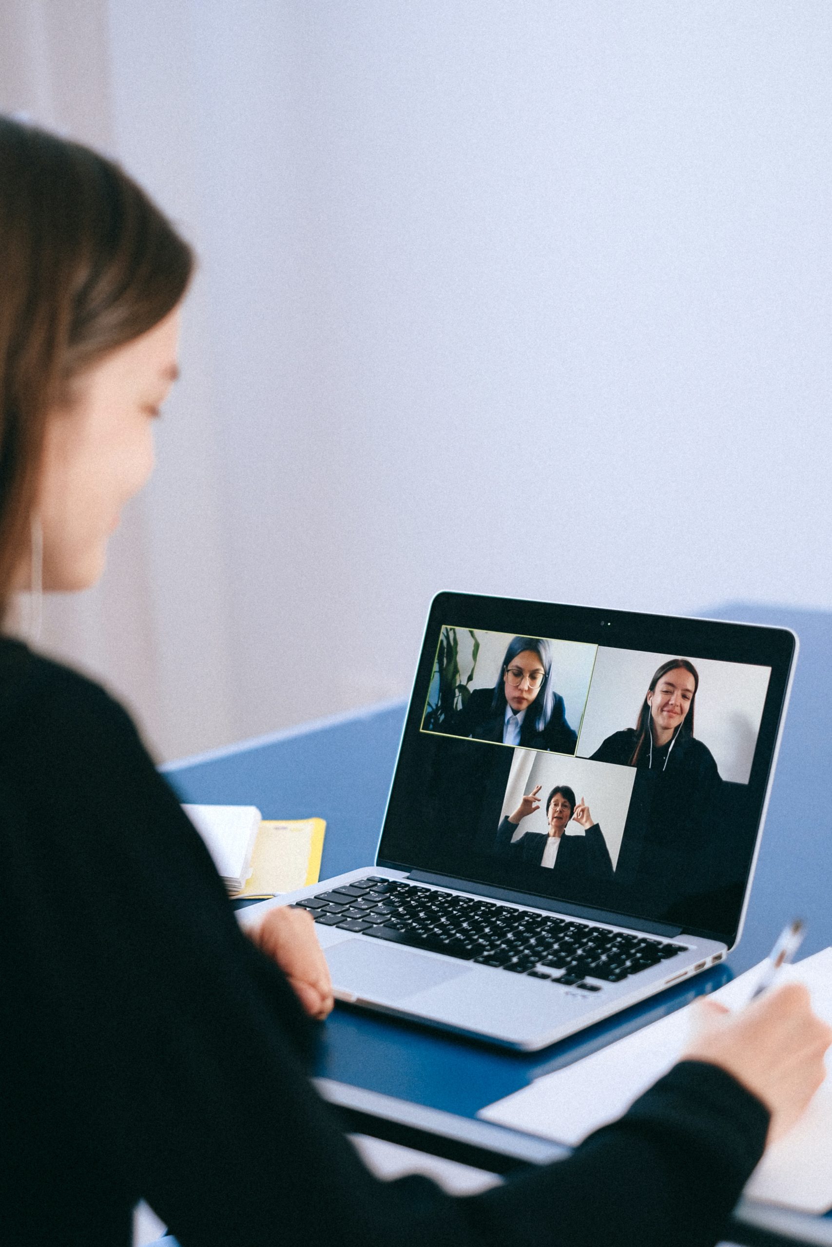 woman sitting on laptop on a Zoom video call
