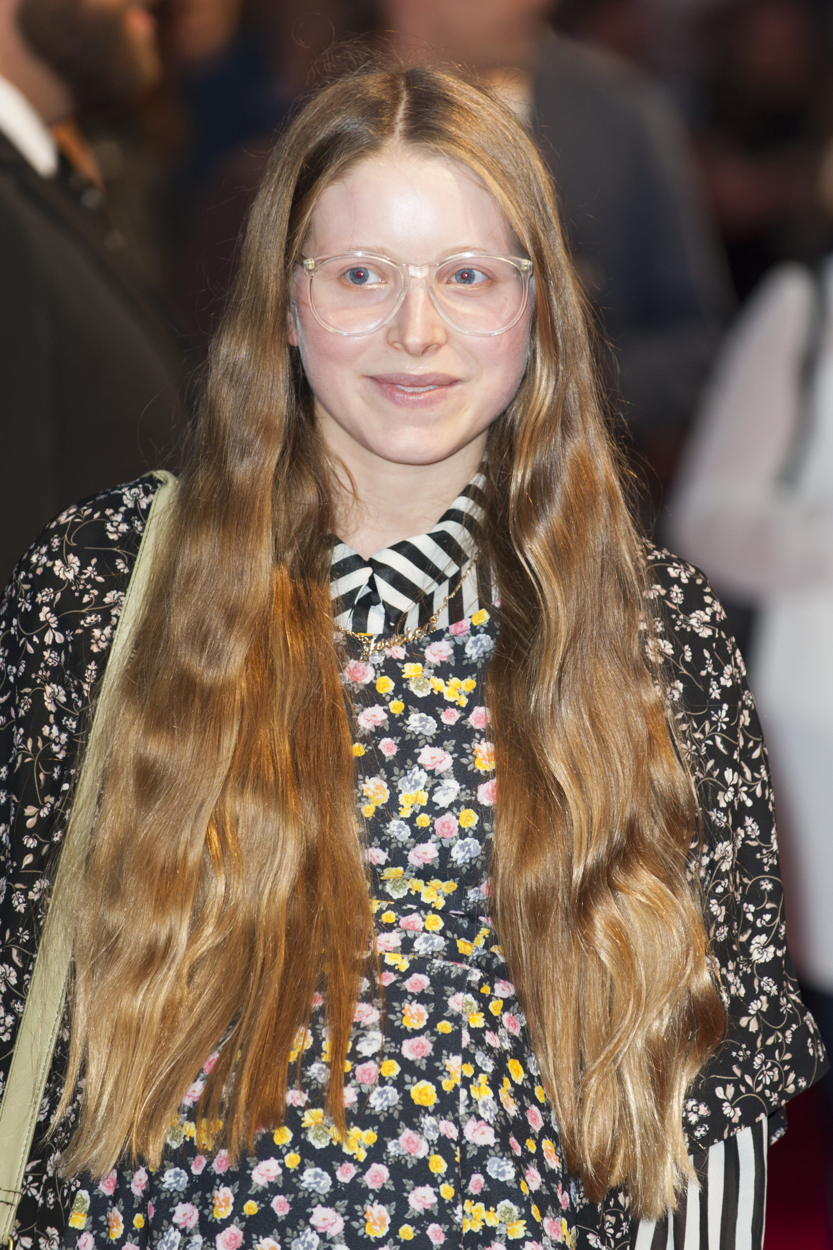 Actress Jessie Cave smiling at a red carpet event