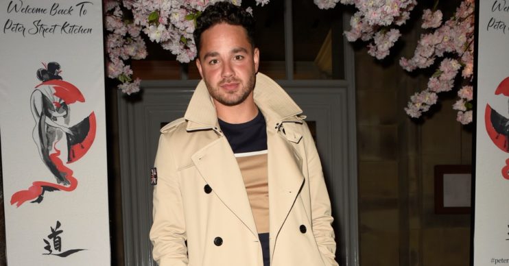 Adam Thomas in beige raincoat