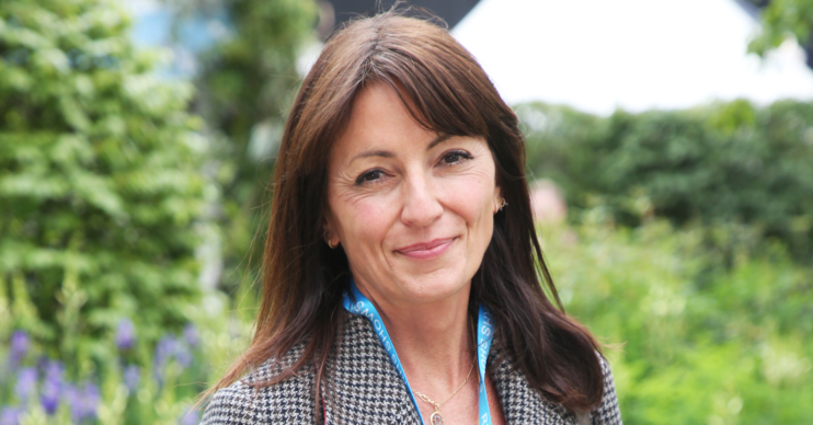 Davina McCall posing against a backdrop of trees