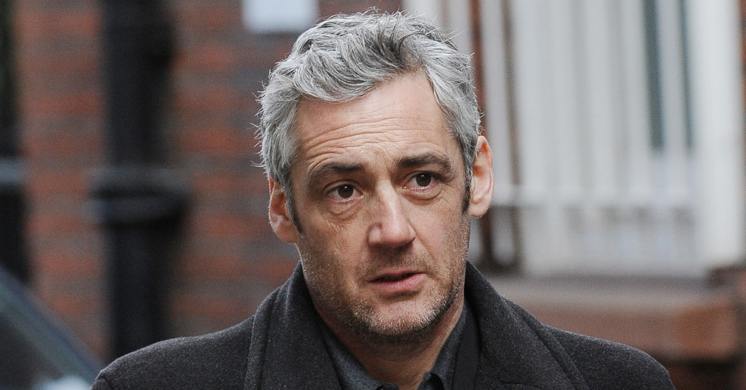 EastEnders actor Michael Higgs in a grey overcoat