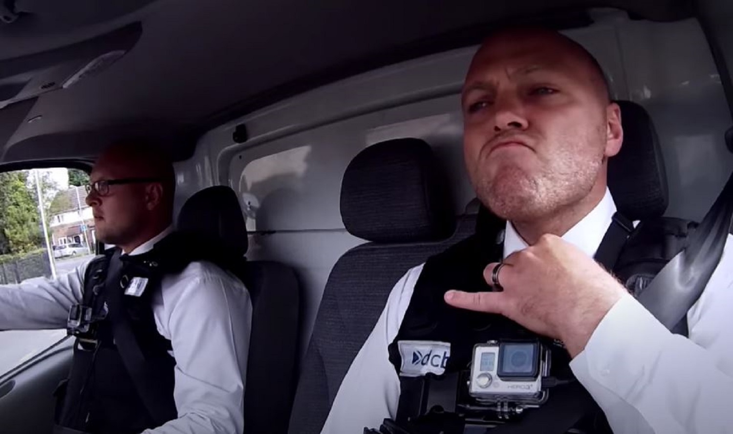 two bailiffs in a car