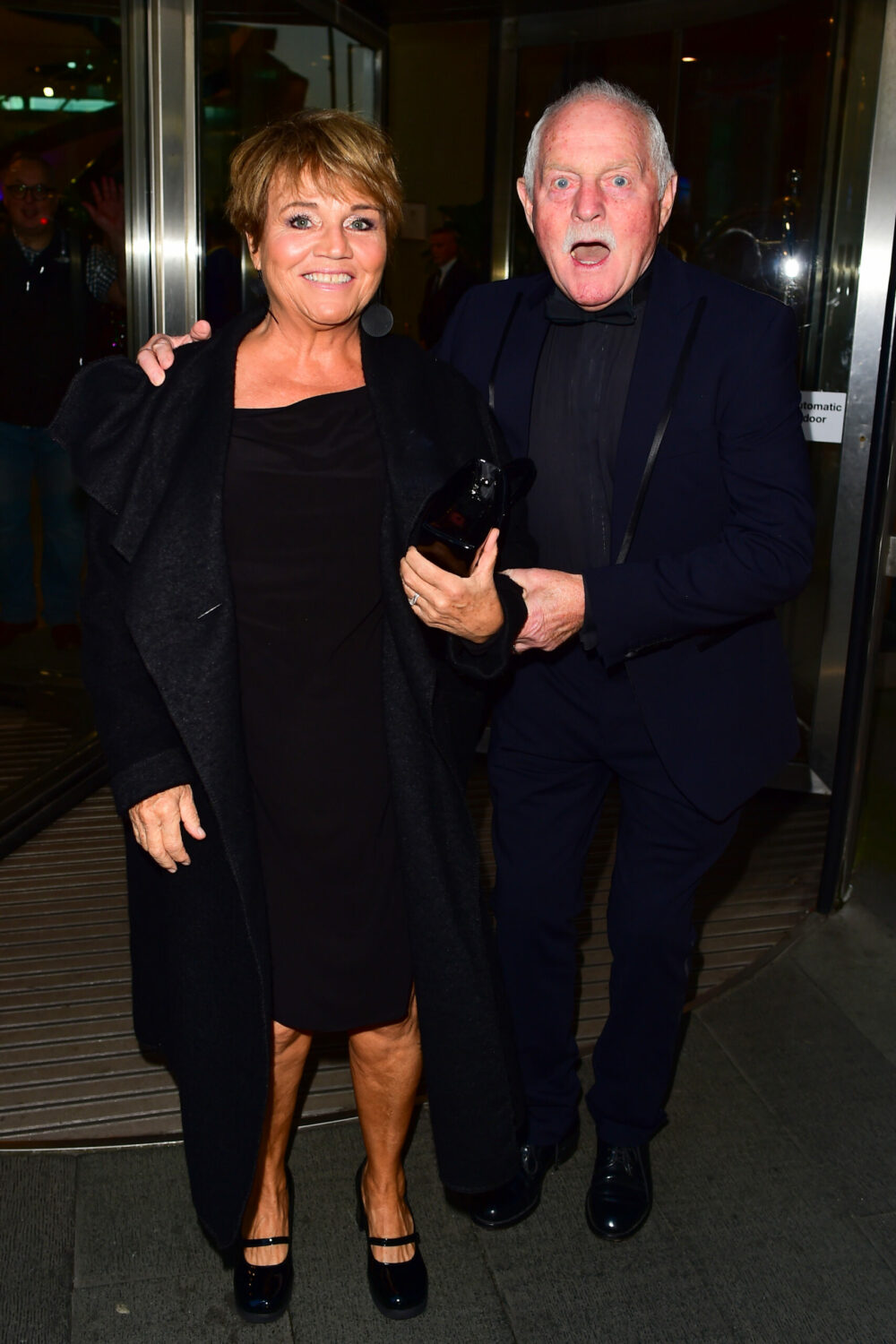 Lesley Dunlop and Chris Chittell leave the Cure Usher Ball and she smiles as he pulls a surprised face