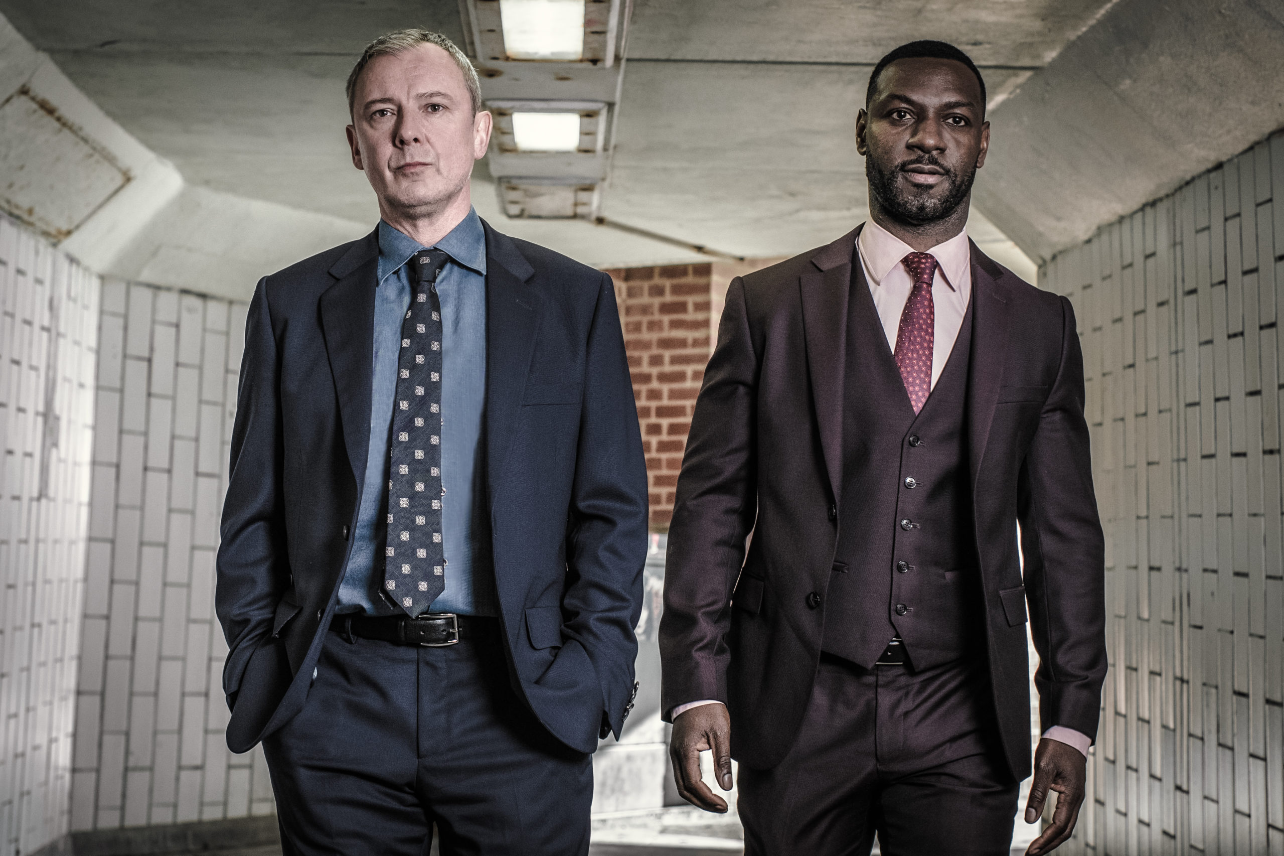 John Simm as DS Roy Grace and Richie Campbell as DS Branson in Grace (Credit: ITV1)